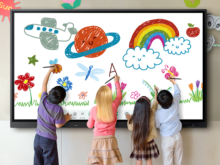 Four children are drawing with pens on the WAD at the same time.