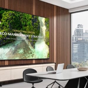 A UHD Signage display is mounted on the wall of a meeting room