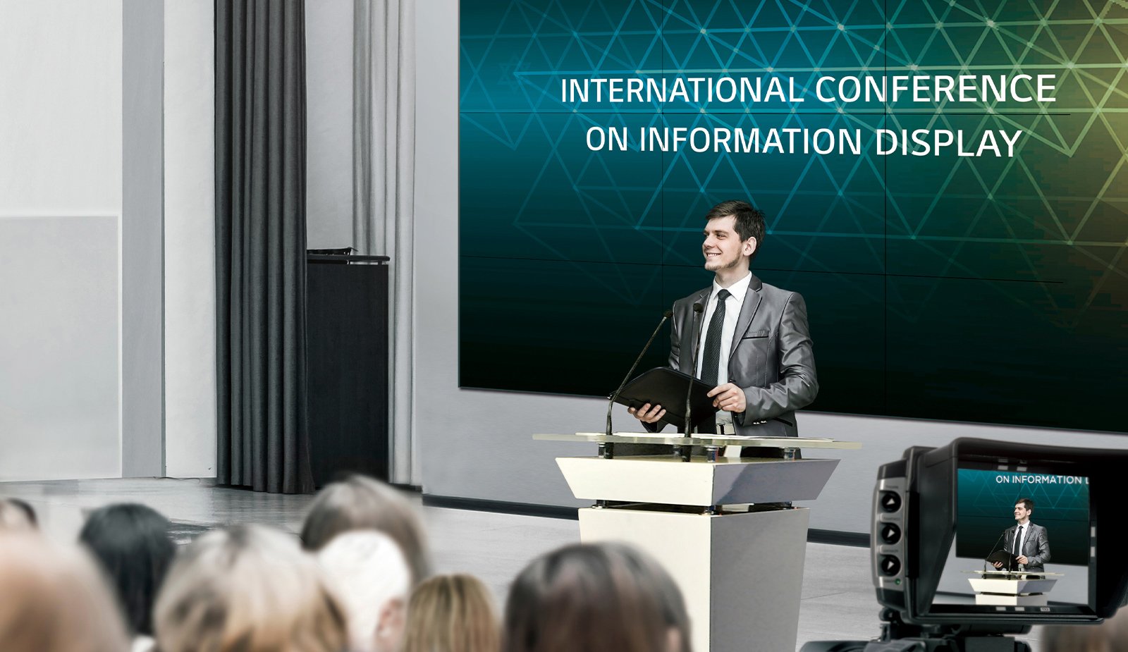 Man presenting in front of a large 55 inch Slim Bezel Series video wall in a conference room