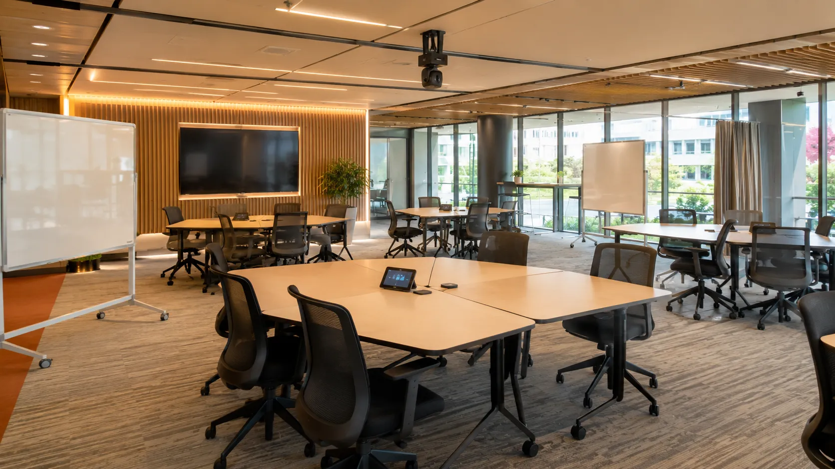 Training Room & Collaboration Space AV — Australian Guide 3 Flexible workshop space with modular tables in cluster arrangement, ceiling mounted PTZ camera and moveable whiteboards — Kickstart Computers Australia