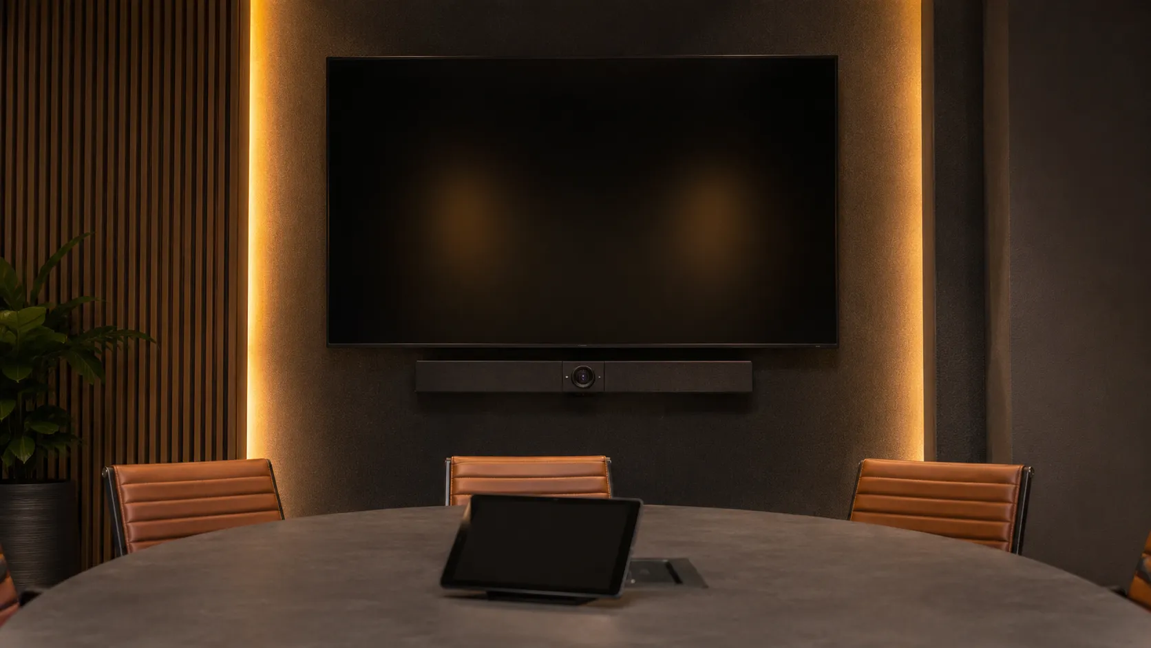 Small Meeting Room & Huddle Space Video Conferencing Australia 12 All-in-one Android video conferencing bar mounted below display in small meeting room, touch controller on table, no laptop required, warm amber lighting — Kickstart Computers Australia
