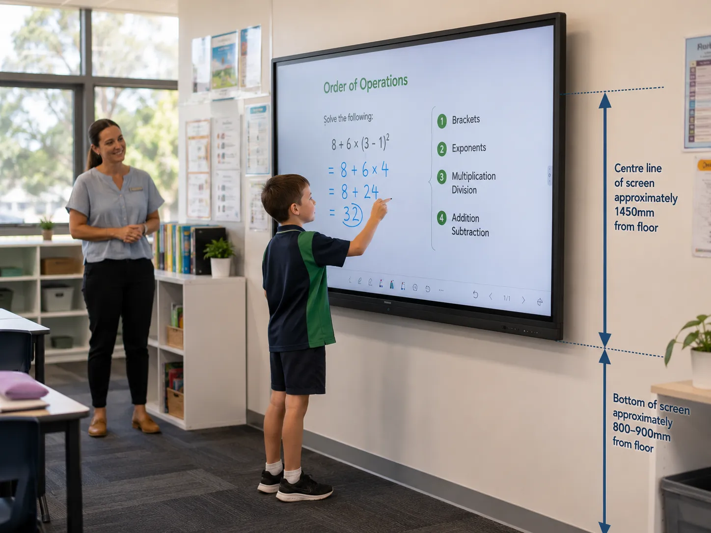 Primary school student comfortably reaching the lower section of an interactive flat panel display showing correct mounting height